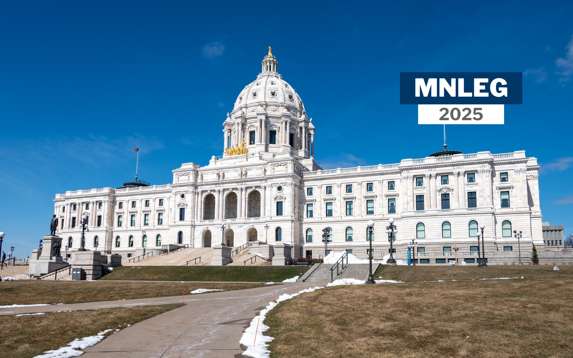 The Minnesota Capitol building in St. Paul, with a blue sky and a smattering of snow on the ground. Small text says "MNLEG 2025"