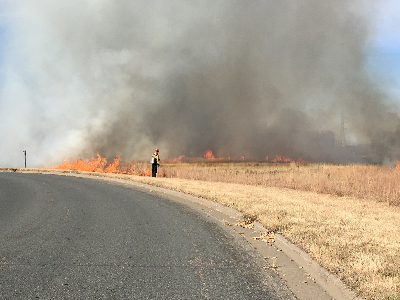 Burn crew along the edge of the prairie burn