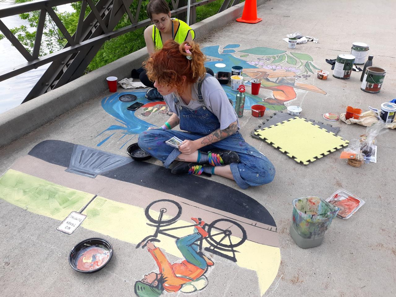 Artists work on the 2019 stormwater mural at Lake Phalen