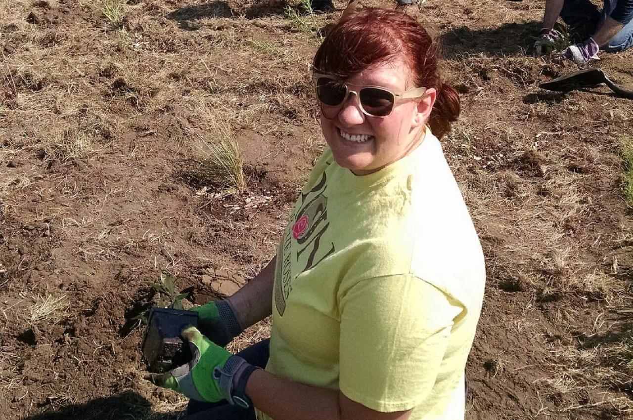 An FMR Vermillion Stewards volunteer plants a pollinator patch.