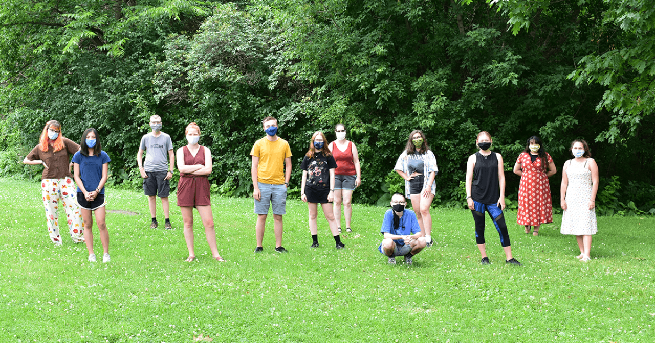 Program participants stand in grass