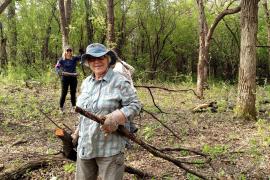 SuperVolunteer Mary hauling buckthorn at last year's event