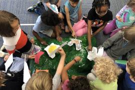 Students work with a watershed model