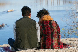 Two people sitting on riverbluff