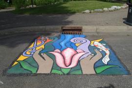 Storm drain mural contains music and fish to connect it to como park and hands representing our responsibliity to care for the lake