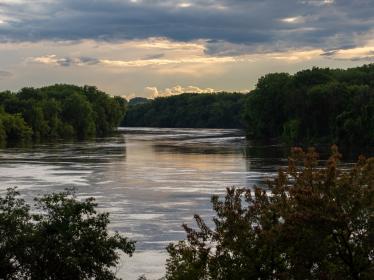 High waters along the tree-lined banks of the Mississippi River in St. Paul