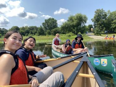 ESI fellows smile in canoes