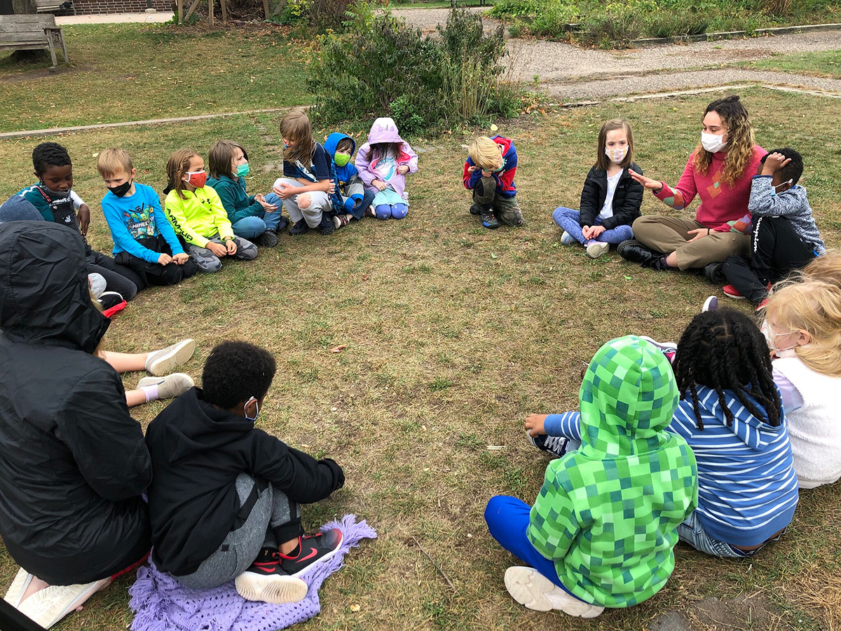 Megan with students in a circle